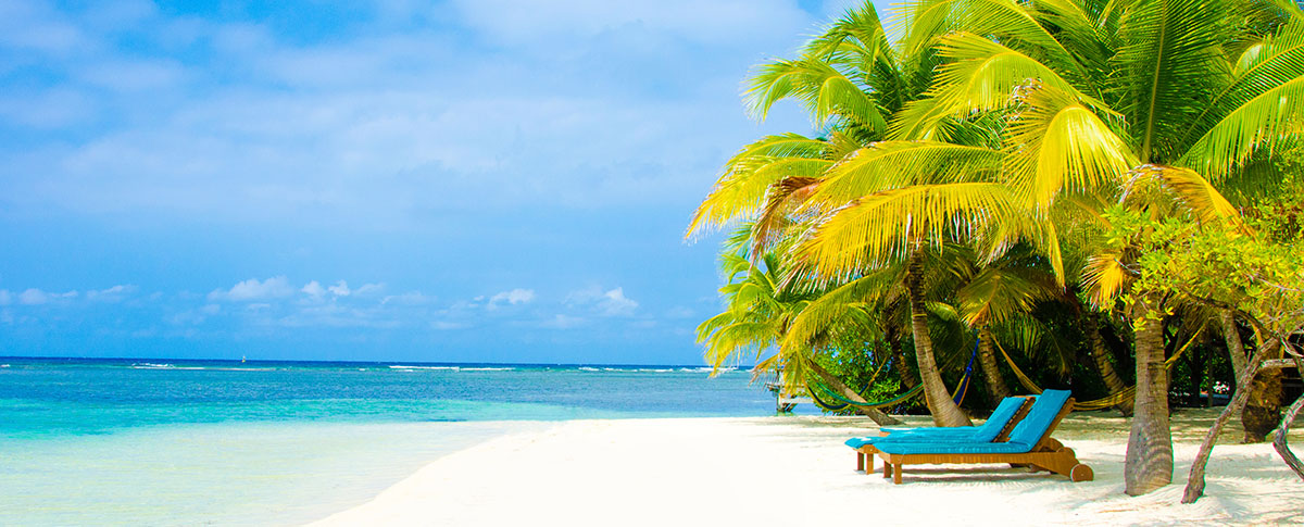 Two deck chairs on a tropical beach